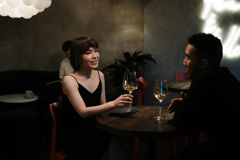 a man and a woman sitting at a table with wine glasses, taken with sony alpha 9, asian female, single figure, serving suggestion