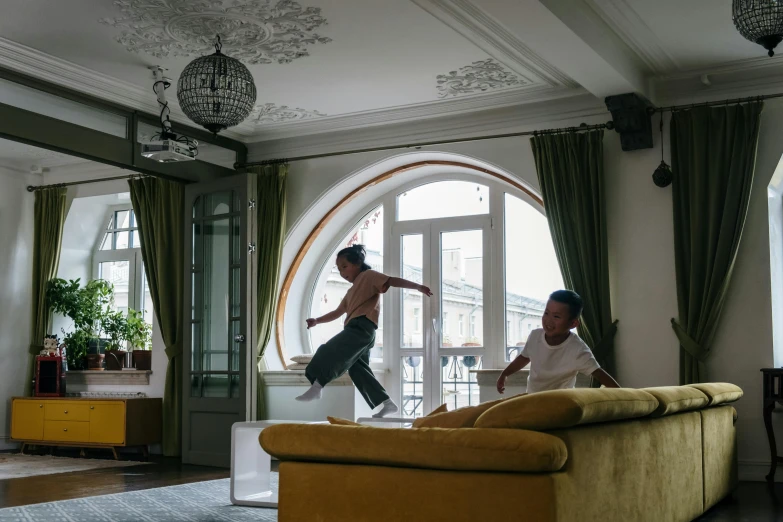 two men jumping in the air in a living room