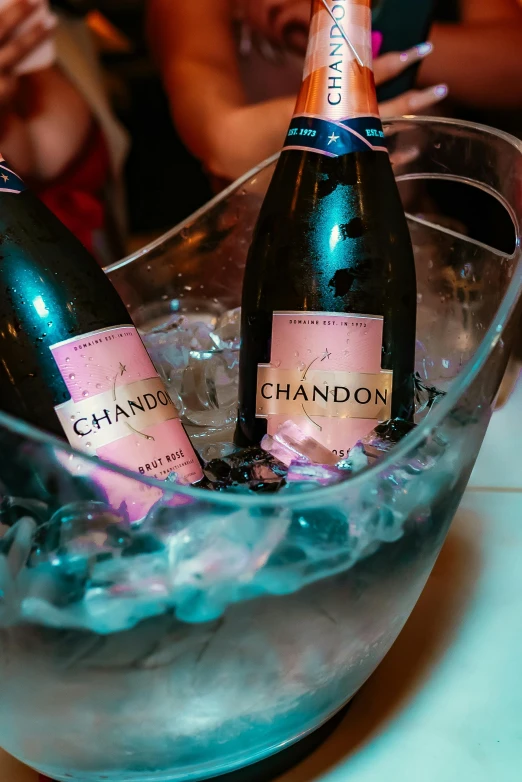 two bottles of champagne are sitting in an ice bucket