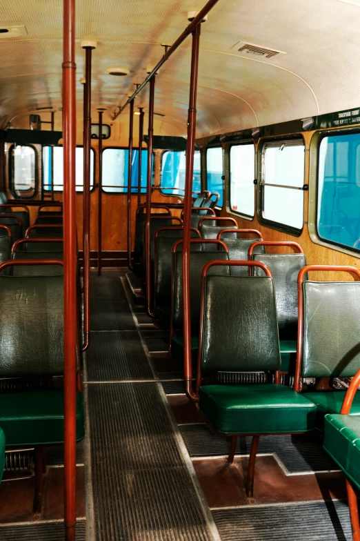 a bus filled with lots of green seats, an album cover, inspired by Wes Anderson, unsplash, modernism, 2 5 6 x 2 5 6 pixels, ship interior, afternoon sunlight, no - text no - logo