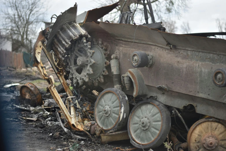 a destroyed tank sitting on the side of a road, a portrait, hurufiyya, exposed wires and gears, avatar image, close-up photo