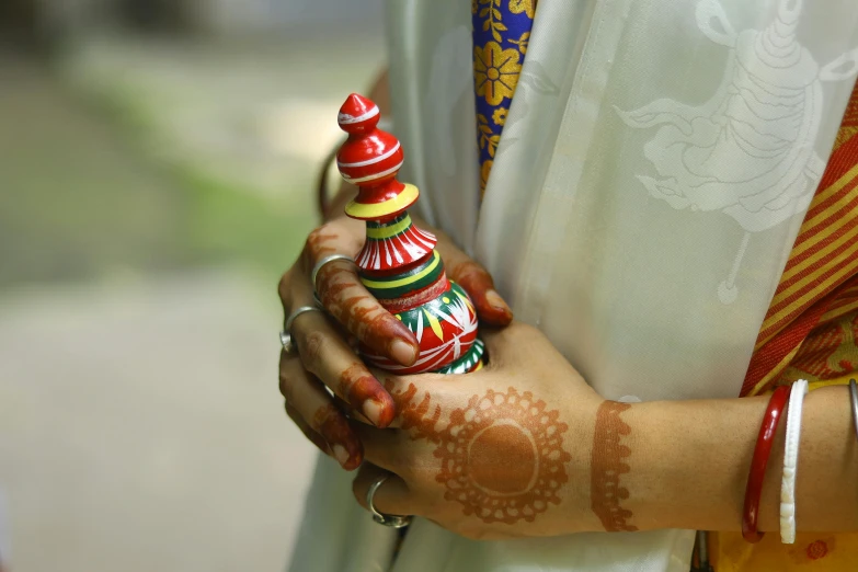 this is a woman with henna and tattoos on her hands