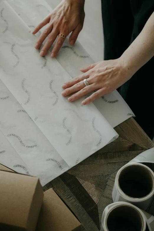 someone is making decorative patterned papers out of recycled materials