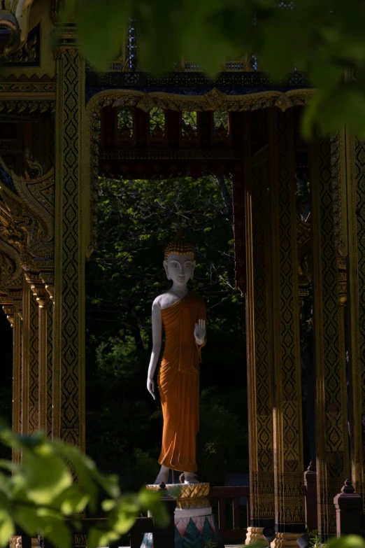 a white and orange statue on top of a white pedestal