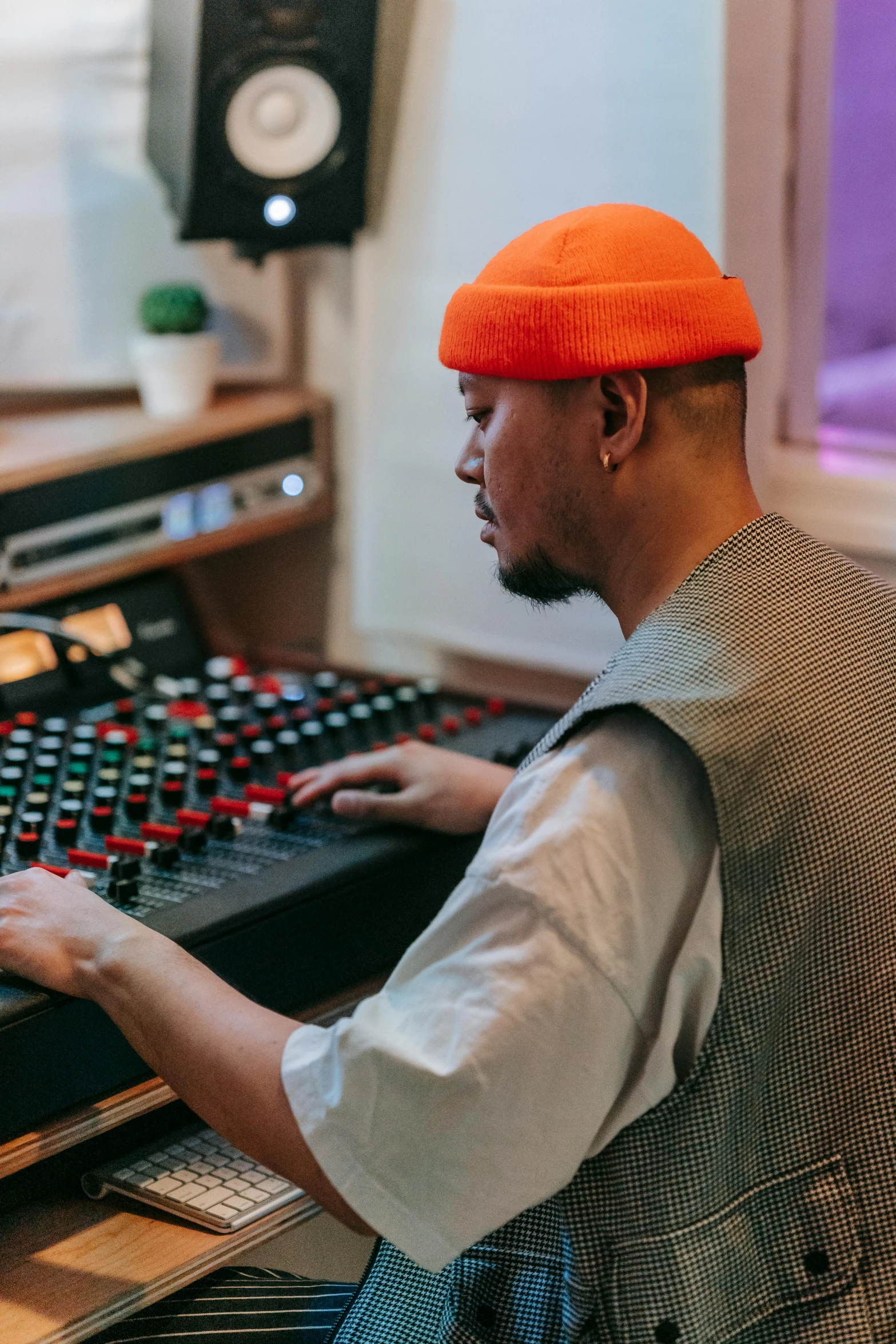 a man sitting in front of a mixing desk, trending on pexels, wearing a red backwards cap, rex orange county, jesper esjing, best practice