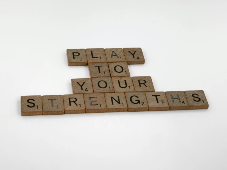 word play on brown tiles with the words strength spelled