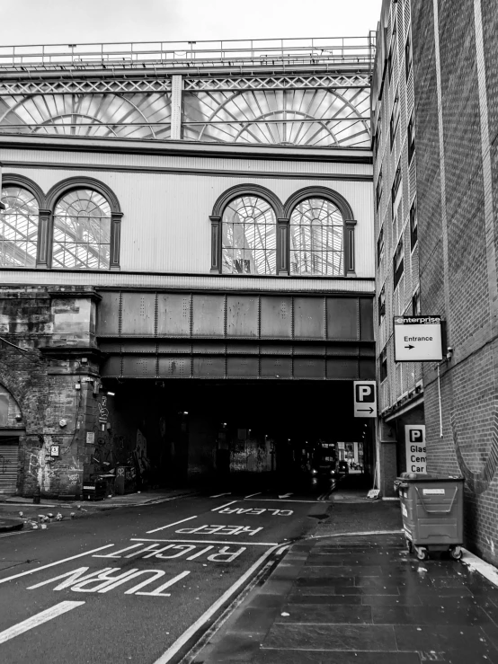 an old street near a tall building with large arched windows