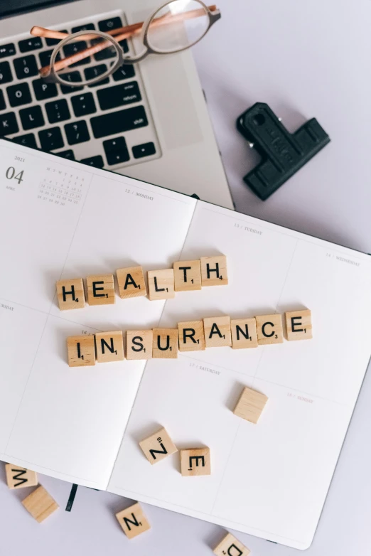the word health insurance spelled in scrabbles next to a laptop, a picture, unsplash, renaissance, square, thumbnail, premium, iso