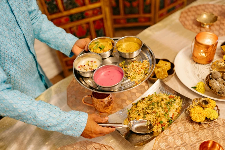 the person is carrying a plate of food with some sauce