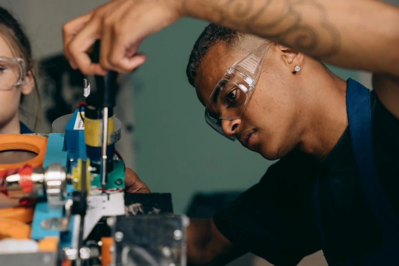 a man and a little girl working on a project, by Thomas Furlong, pexels contest winner, renaissance, a teen black cyborg, man with glasses, handling laboratory equipment, closeup portrait shot