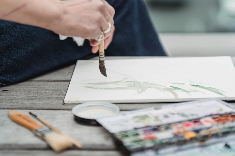 a close up of a person painting on a piece of paper, inspired by Andrew Wyeth, pexels contest winner, botanical artwork, japan watercolour, long brush strokes, jpeg artefacts on canvas