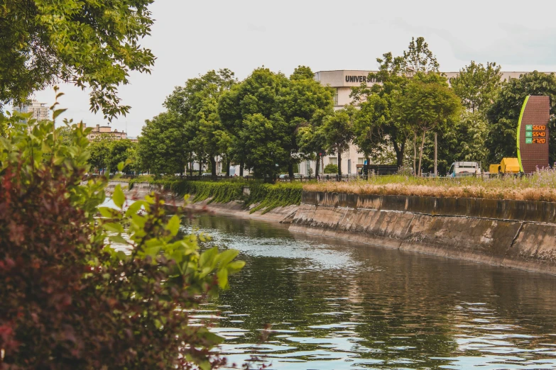 a man riding a skateboard down the side of a river, a picture, inspired by Miyagawa Chōshun, unsplash, shin hanga, the city is full of green plants, 🚿🗝📝, grass field surrounding the city, in karuizawa