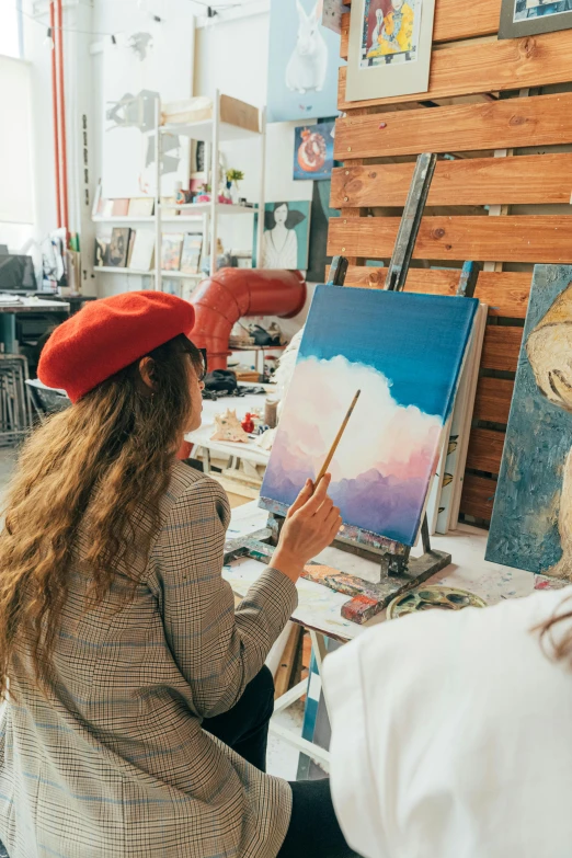 a woman in a red beret painting on a canvas, trending on pexels, a painting of two people, artstudio, bright sky, millennial vibes