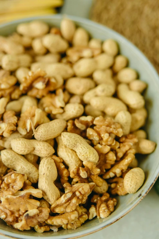 a bowl filled with nuts on top of a table, full product shot, zoomed in, detail shot, medium