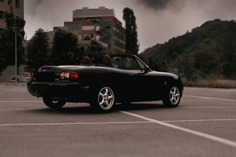 a black sports car parked in an empty parking space