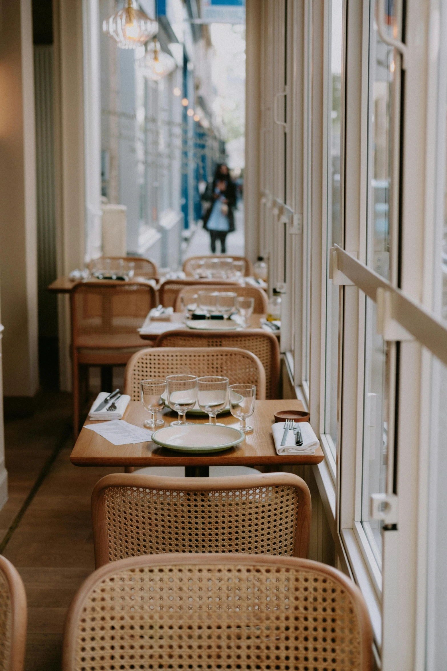 a room filled with tables and chairs next to a window, by Raphaël Collin, trending on unsplash, restaurant menu photo, woman, french noveau, amanda lilleston