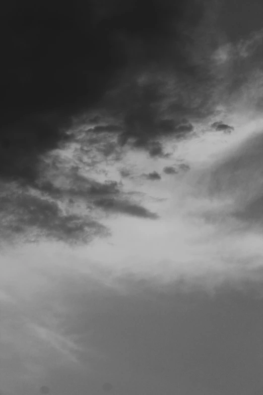 a plane flying high in the cloudy sky