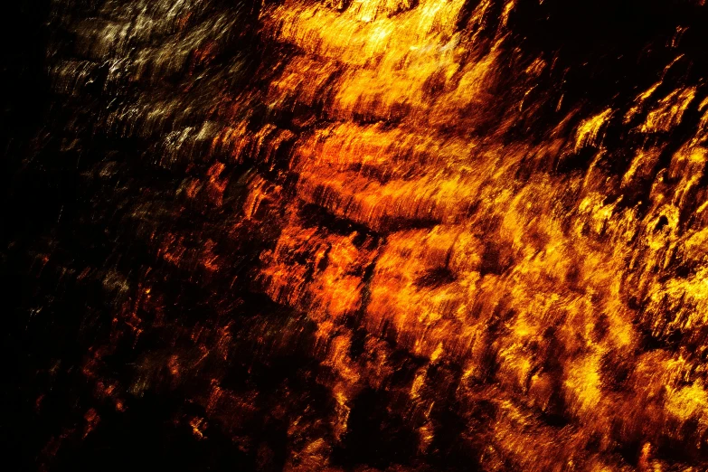 a blurry image of a man with a beard, inspired by George Frederic Watts, unsplash, lyrical abstraction, glowing gold embers, glass texture, cave wall, ripples