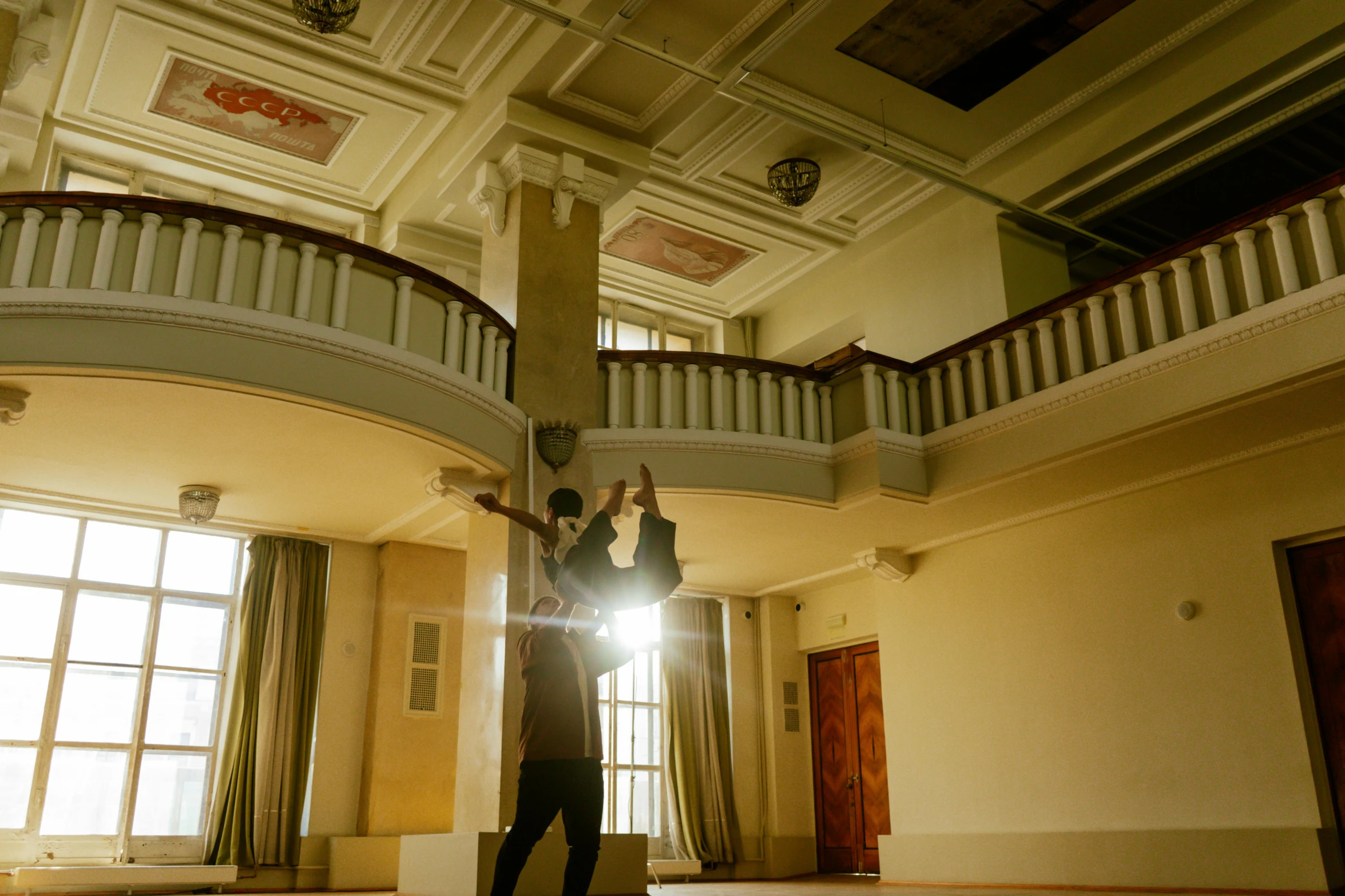 a man and woman standing in a large hall