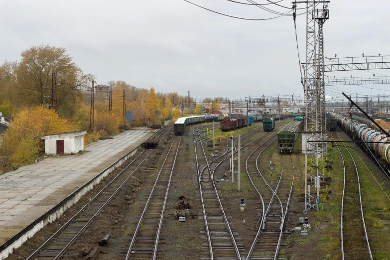 a large long train on a steel track, by Sven Erixson, unsplash, rostov city, autumn season, trading depots, 2000s photo