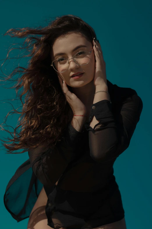 a woman with glasses posing for a picture, an album cover, inspired by Elsa Bleda, pexels contest winner, windy floating hair!!, portrait sophie mudd, wavy black hair, still from a music video