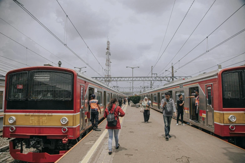 a couple of trains that are next to each other, by Alejandro Obregón, pexels contest winner, a red cape, manila, unmistakably kenyan, terminal