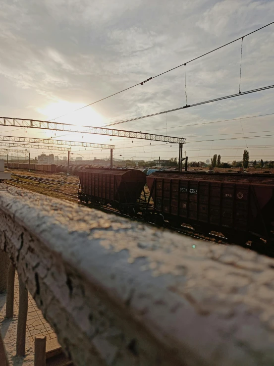 a train traveling down train tracks next to a bridge, by Sven Erixson, unsplash, graffiti, late afternoon sun, soviet yard, cinematic outfit photo, panoramic