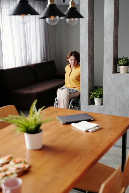 a  sitting in a chair in a home with dining room furniture