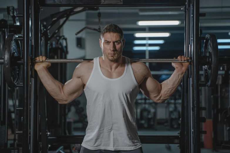 a man lifts a bar at the gym