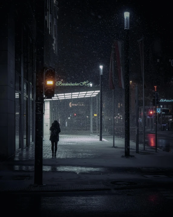 a person walking down a street at night, inspired by Elsa Bleda, realism, snowfall, looking sad, standing in a city center, unsplash photo contest winner