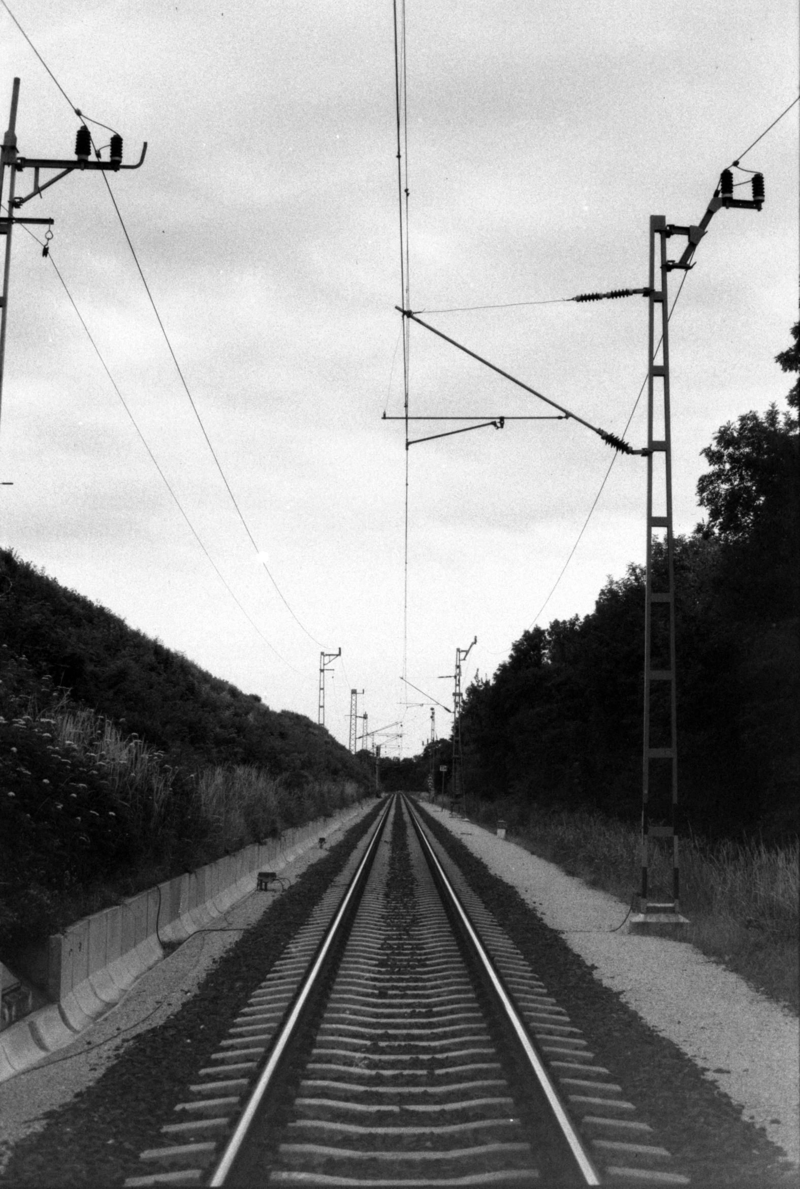 a black and white photo of a train track, hannover, powerlines, ( ( photograph ) ), 1990s photograph