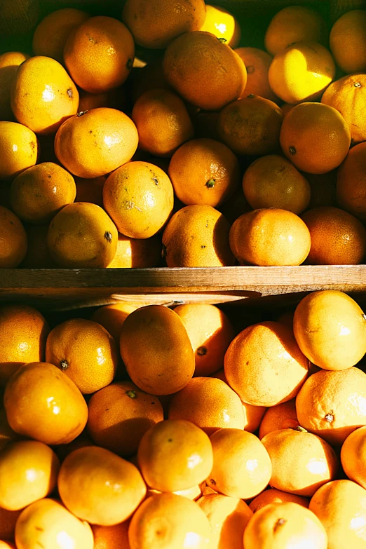 a pile of oranges sitting on top of a table, yellow, local foods, sunshine, digital image