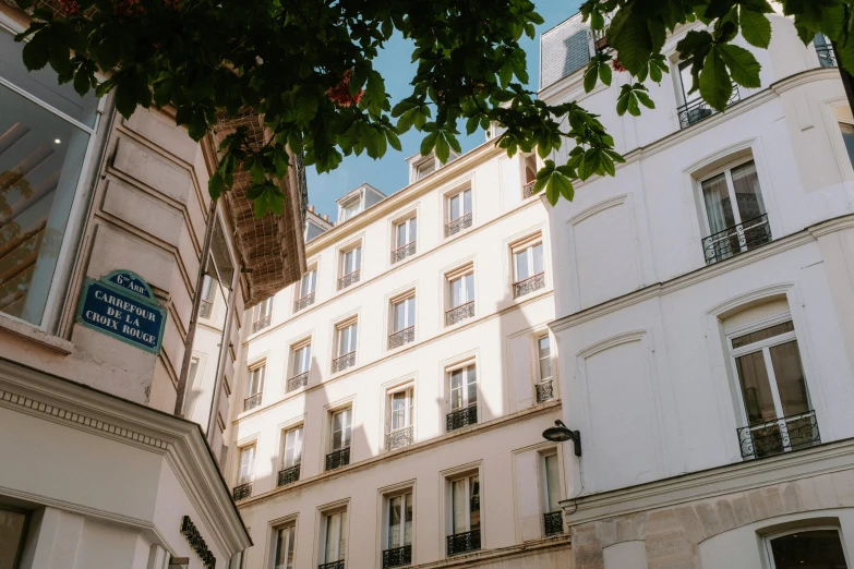 a couple of buildings that are next to each other, inspired by Albert Paris Gütersloh, unsplash, paris school, white building, 1 7 9 5, fan favorite, street of teal stone