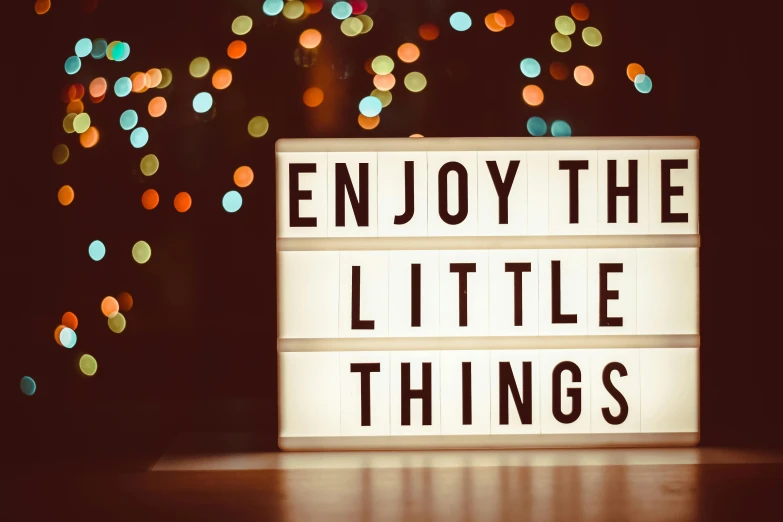 a sign that says enjoy the little things, a picture, by Emma Andijewska, shutterstock, lights on, trinkets, led screens, avatar image