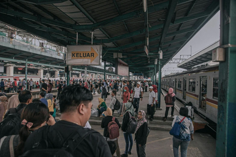 a group of people waiting at a train station, pexels contest winner, sumatraism, thumbnail, 🚿🗝📝, square, in the center of the image