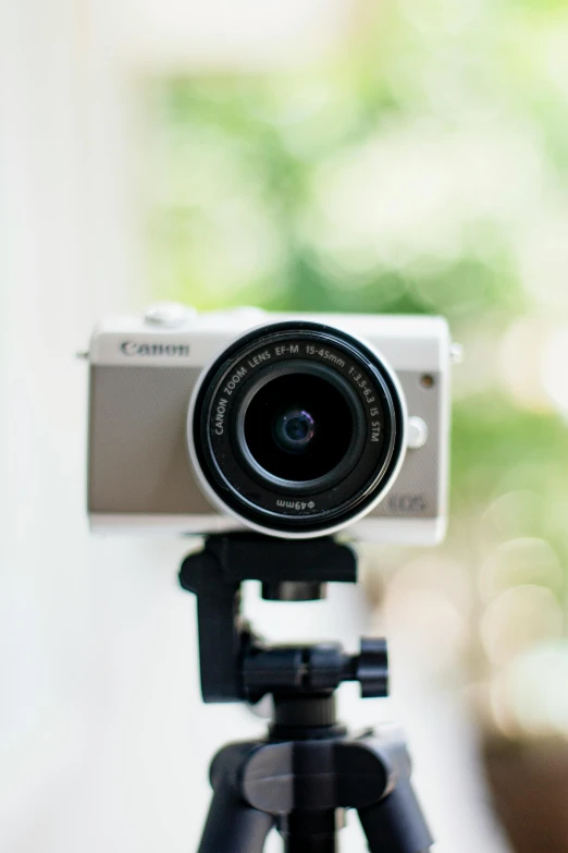 a close up of a camera on a tripod, by Carey Morris, unsplash, white, alexa mini, a long-shot from front, frontal shot