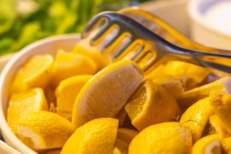 a close up of a bowl of lemons with a fork, bowl filled with food, cuts, thumbnail, very sunny