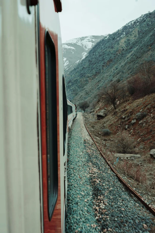 a train traveling along a mountain side side