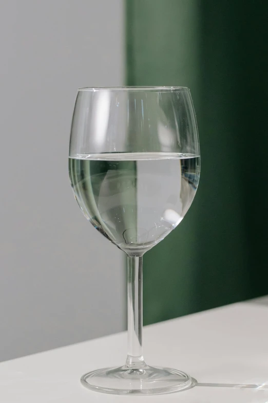 there is a wine glass with water in it