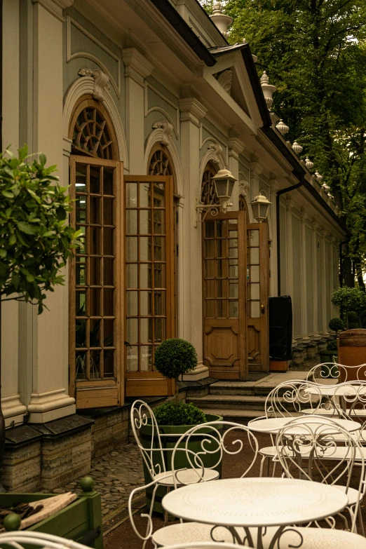 tables and chairs in front of buildings in the afternoon