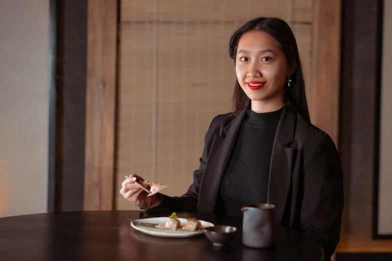 a woman sitting at a table with a plate of food, a portrait, unsplash, mingei, wearing a black jacket, darren quach, 15081959 21121991 01012000 4k, with long