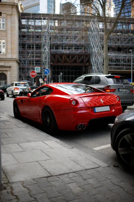 a red sports car driving down the street