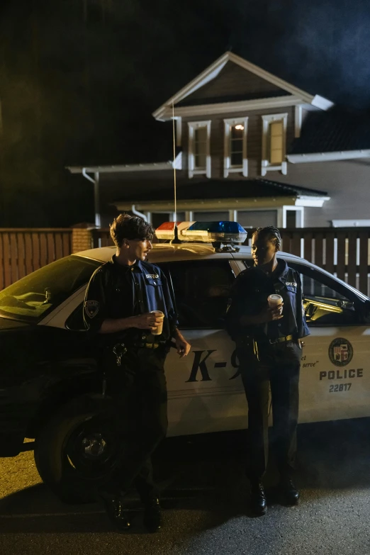 two police officers standing in front of a police car, by Ryan Pancoast, reddit, happening, dark neighborhood, production still, sk, standing outside a house