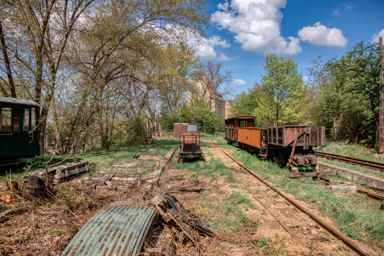 a couple of trains that are sitting in the grass, a portrait, by Arnie Swekel, old lumber mill remains, 2 0 2 2 photo, taken in silver dollar city, “derelict architecture buildings