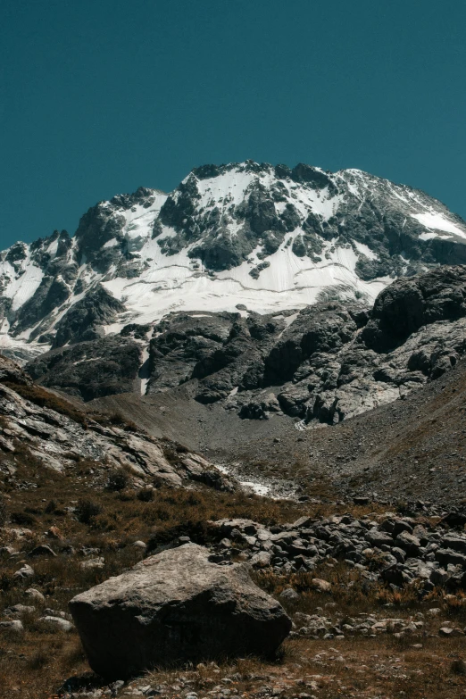 the mountains are covered in snow and grass