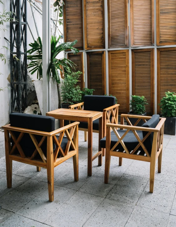 four black leather cushions sit together on the back patio furniture