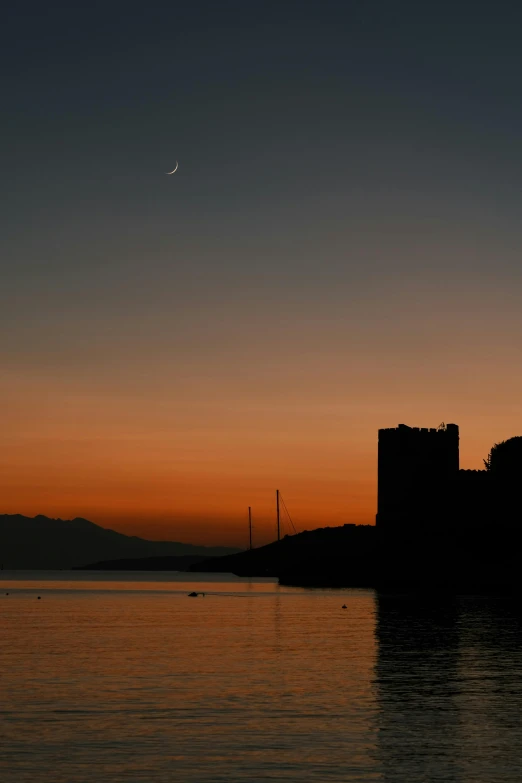 a castle sitting on top of a body of water, by Alexis Grimou, break of dawn on venus, harbour, crescent moon in background, phot