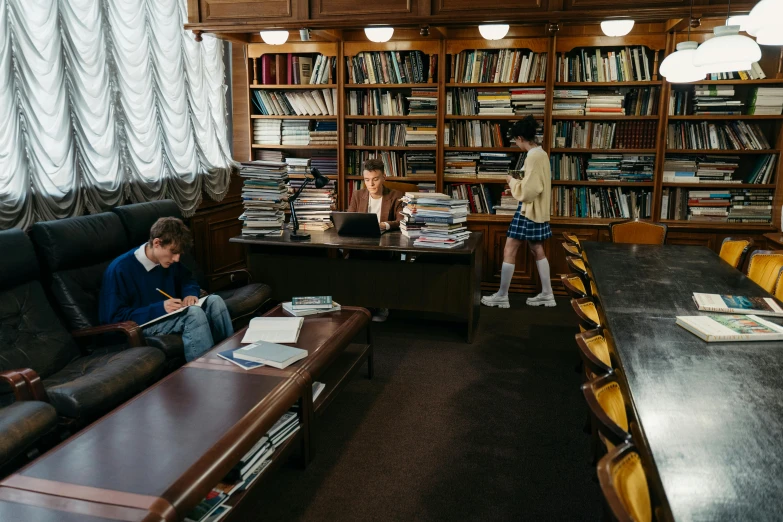 a couple of people sitting on a couch in a library, unsplash contest winner, paris school, russian academicism, multiple desks, medium long shot, inside elementary school