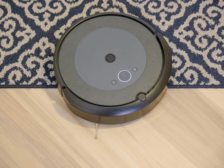 a robotic vacuum sitting on top of a wooden floor, a portrait, by Julia Pishtar, dark grey carpet, shot on canon eos r5, けもの, cortana