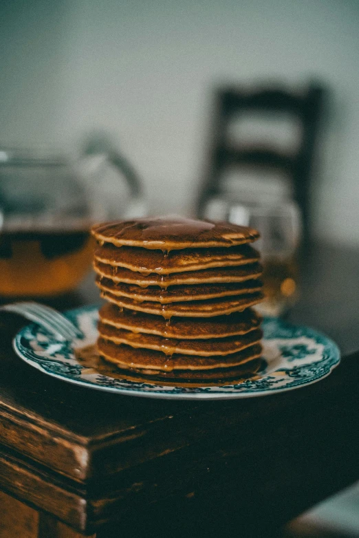 a stack of cookies sitting on a plate with glasses next to it